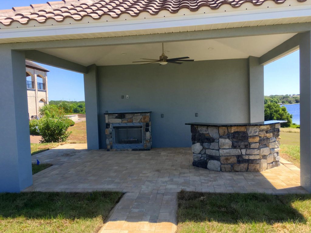 Large tuscan backyard brick patio kitchen photo in Orlando with a gazebo