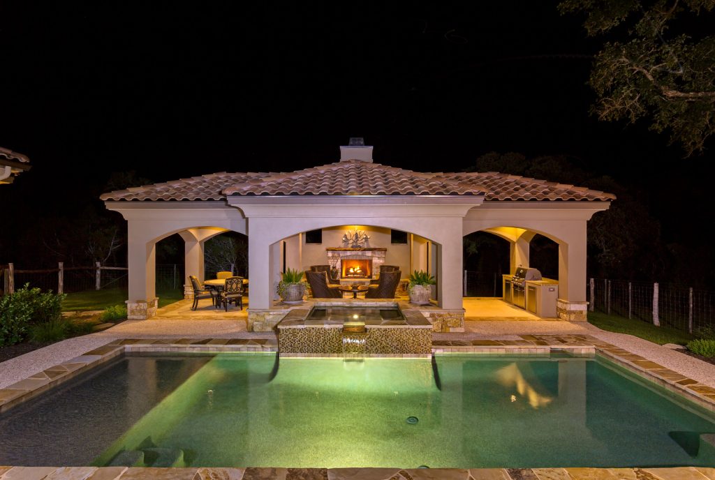 Large tuscan backyard concrete and rectangular lap pool photo in Austin