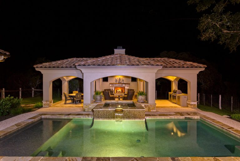 Large tuscan backyard concrete and rectangular lap pool photo in Austin