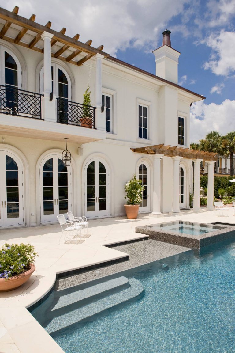 Large tuscan backyard pool photo in Jacksonville