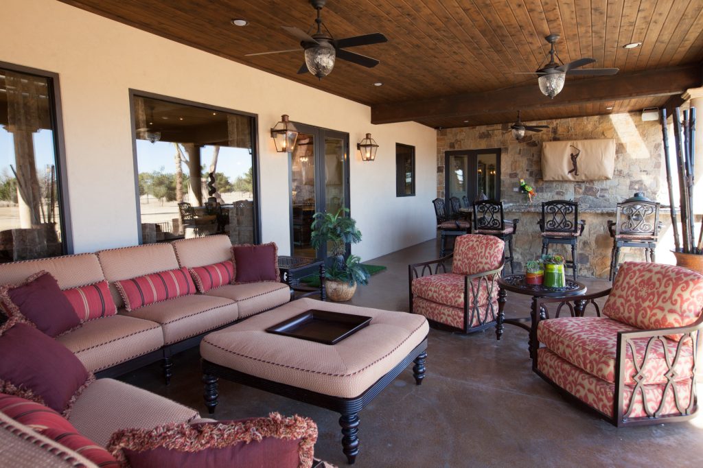 Large tuscan backyard stamped concrete patio kitchen photo in Dallas with a roof extension