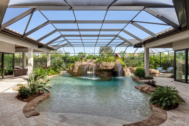 Large tuscan backyard stone and custom-shaped natural pool fountain photo in Orlando