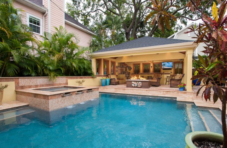 Large tuscan backyard stone and rectangular lap pool house photo in Tampa