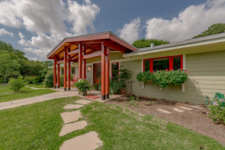 Large zen stone front porch photo in Austin with an awning by Stearns Design Build | Outdoor Photos | Porch | Landscaping | Landscape Design | Outdoor Living Space | Porch Design Ideas | Outdoor Living Space Ideas | Backyard Design