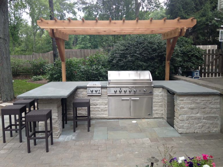 Limestone Grill Surround and Peninsula with Rock Faced Bluestone Counter Top, Cedar Pergola and DCS 48" Grill. Dan Wells Elan Landscape Development Inc.