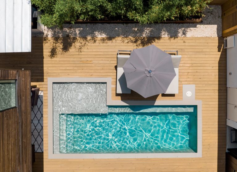 Living area of the house wraps around the pool, making it an integral part of the space.