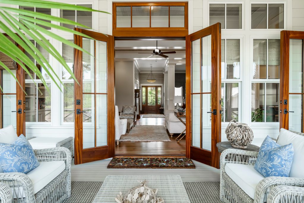 Love this photo, view from front back porch door to the front door - beautiful, open floor plan. This is what low country, cottage style living looks like! by Coastal Signature Homes | Outdoor Photos | Porch | Landscaping | Landscape Design | Outdoor Living Space | Porch Design Ideas | Outdoor Living Space Ideas | Backyard Design