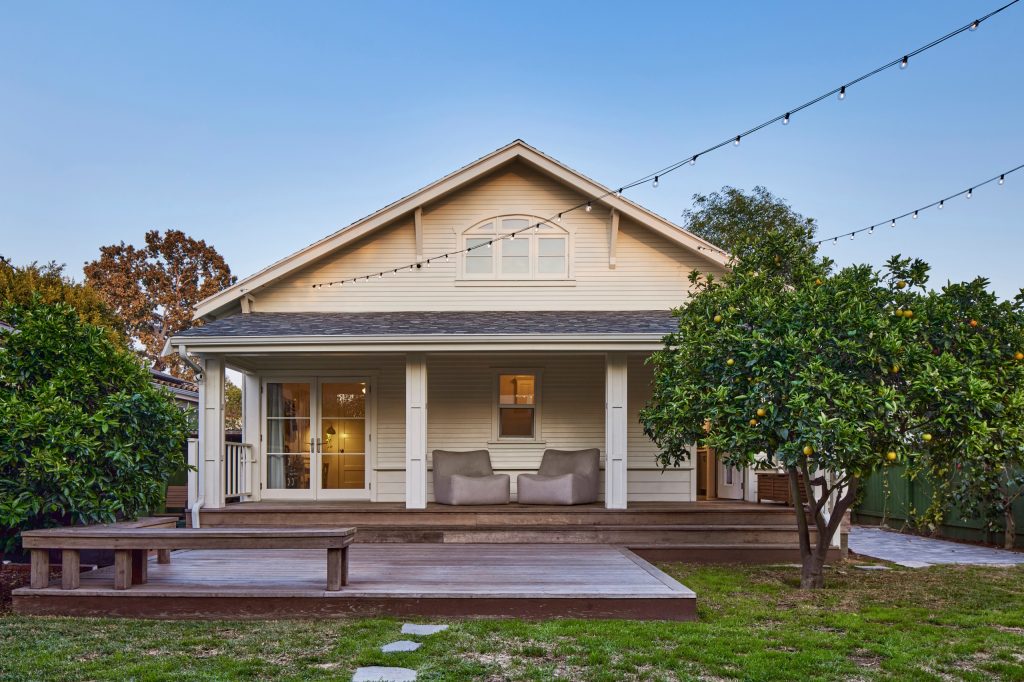 Main House with covered porch and attached wood deck