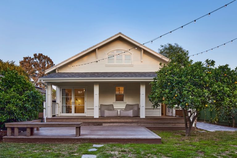 Main House with covered porch and attached wood deck