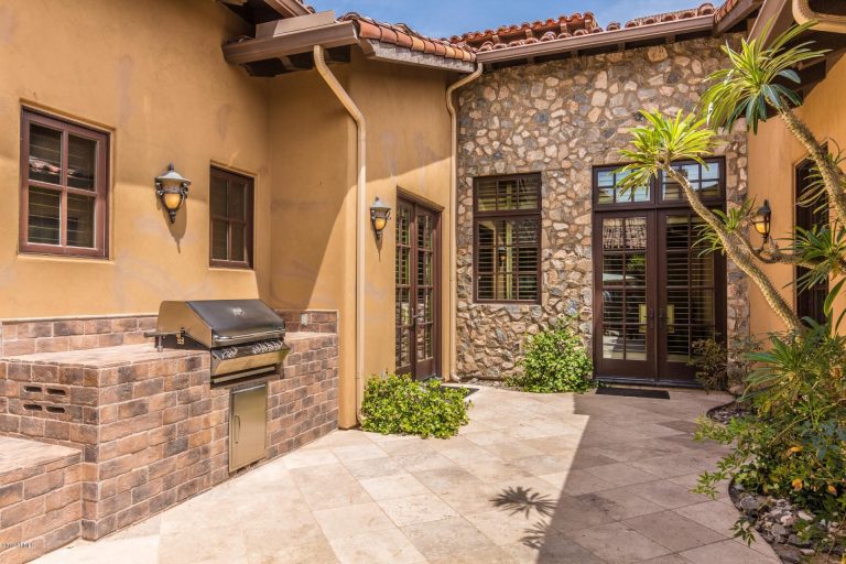 Mediteranean Style Home with Private courtyard having built in BBQ and fireplace.