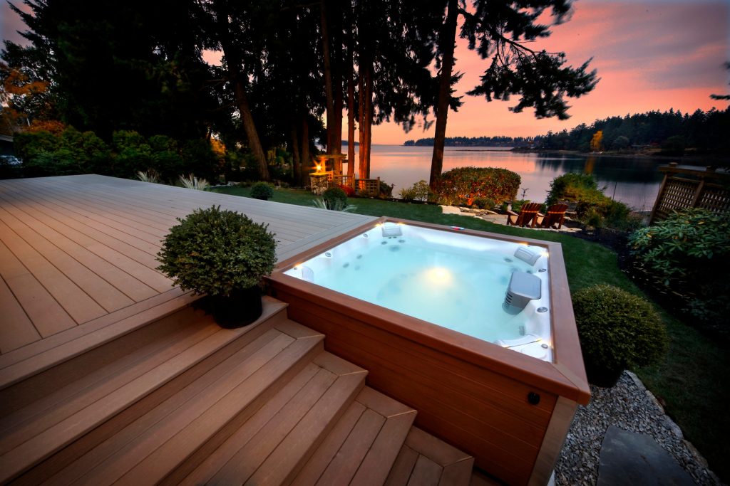 Mid-sized arts and crafts backyard rectangular aboveground hot tub photo in Portland with decking