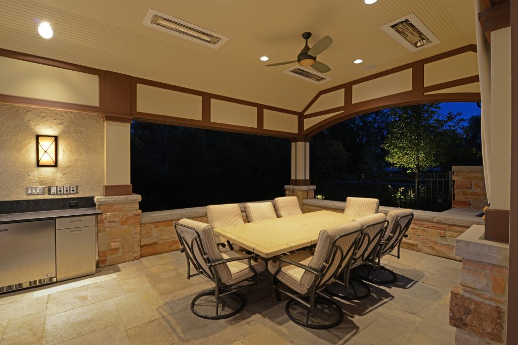 Mid-sized arts and crafts backyard stone patio kitchen photo in Chicago with a roof extension