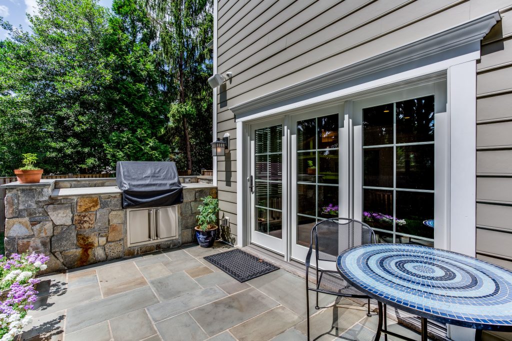 Mid-sized arts and crafts backyard stone patio kitchen photo in DC Metro with no cover