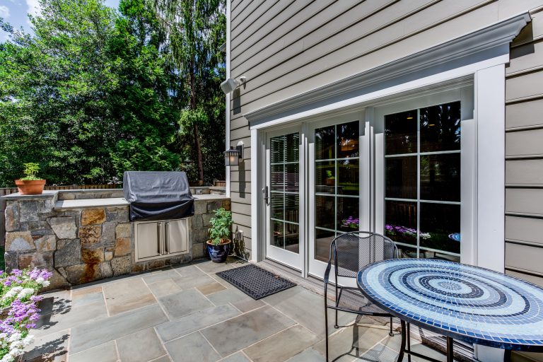 Mid-sized arts and crafts backyard stone patio kitchen photo in DC Metro with no cover