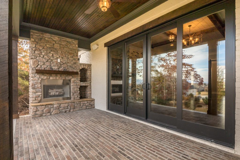 Mid-sized arts and crafts brick back porch idea in Other with a fire pit and a roof extension by New Image Construction | Outdoor Photos | Porch | Landscaping | Landscape Design | Outdoor Living Space | Porch Design Ideas | Outdoor Living Space Ideas | Backyard Design