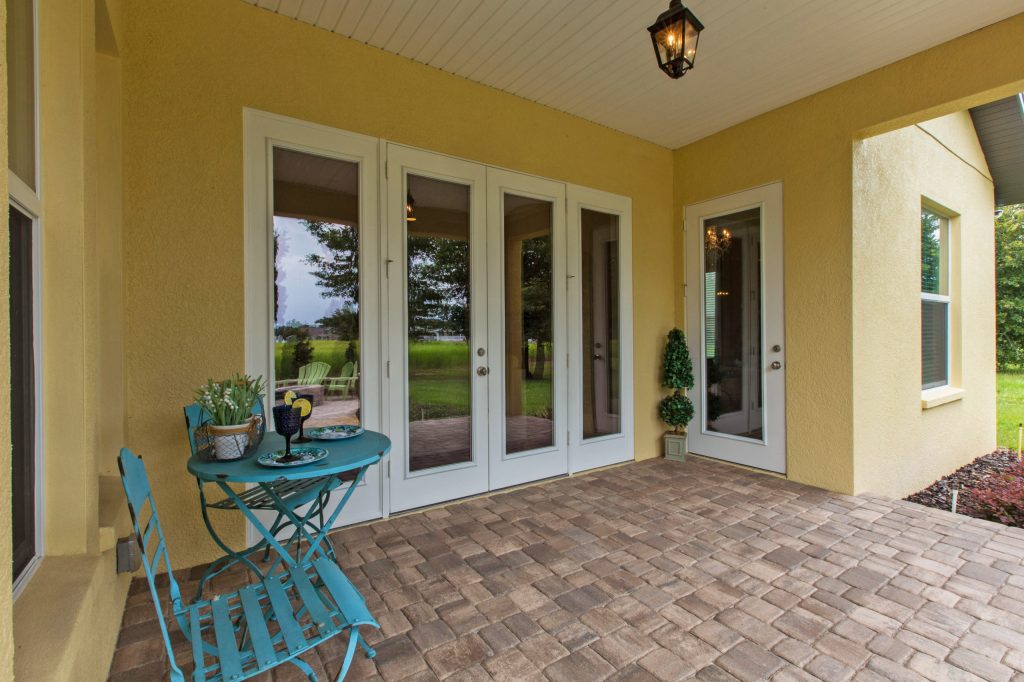 Mid-sized arts and crafts brick back porch idea in Tampa with a roof extension by Radd Builders Inc. | Outdoor Photos | Porch | Landscaping | Landscape Design | Outdoor Living Space | Porch Design Ideas | Outdoor Living Space Ideas | Backyard Design