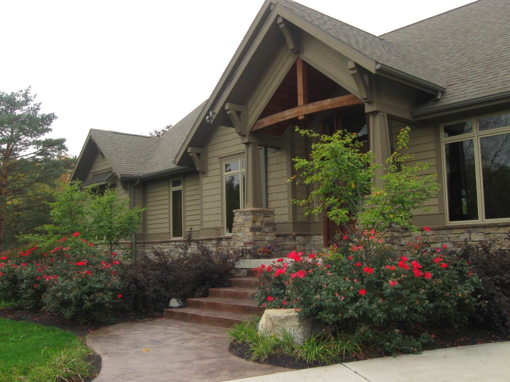 Mid-sized arts and crafts concrete front porch idea in Other with a roof extension by The Site Group | Outdoor Photos | Porch | Landscaping | Landscape Design | Outdoor Living Space | Porch Design Ideas | Outdoor Living Space Ideas | Backyard Design