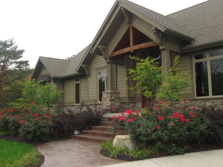 Mid-sized arts and crafts concrete front porch idea in Other with a roof extension by The Site Group | Outdoor Photos | Porch | Landscaping | Landscape Design | Outdoor Living Space | Porch Design Ideas | Outdoor Living Space Ideas | Backyard Design
