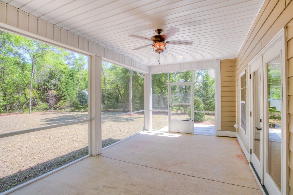 Mid-sized arts and crafts concrete screened-in back porch photo in Other with a roof extension by Riptide Builders, LLC | Outdoor Photos | Porch | Landscaping | Landscape Design | Outdoor Living Space | Porch Design Ideas | Outdoor Living Space Ideas | Backyard Design