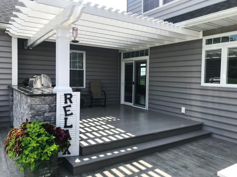 Mid-sized backyard outdoor kitchen deck photo in Other with a pergola
