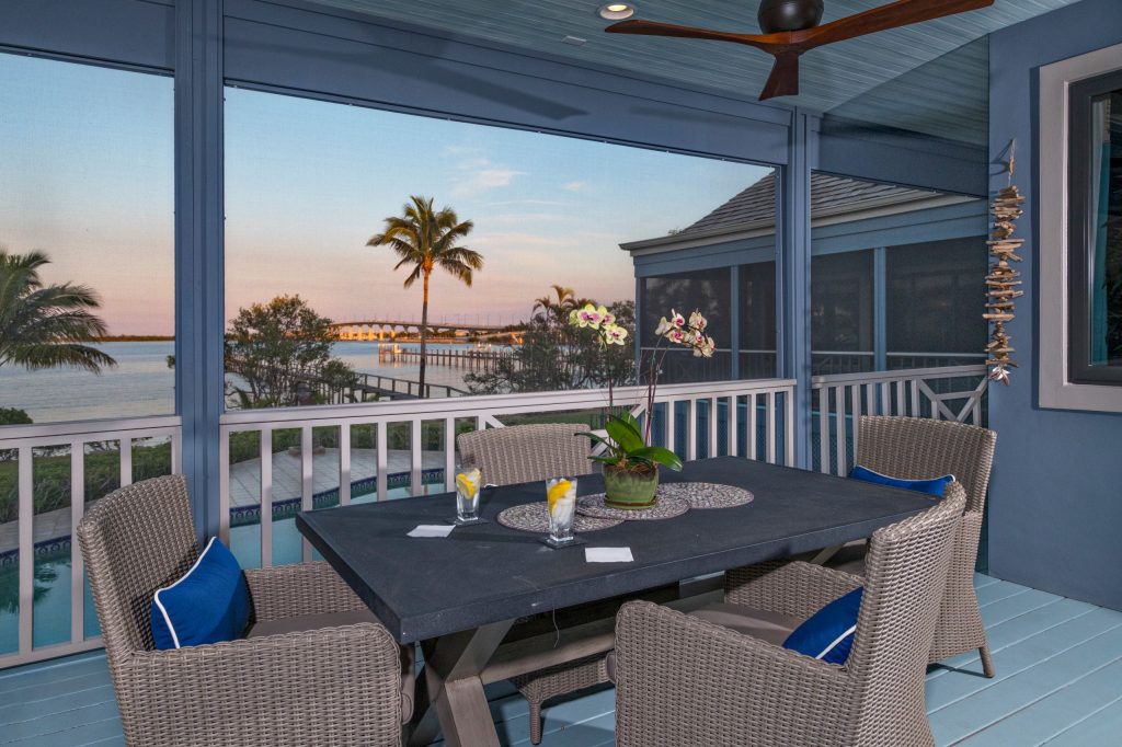 Mid-sized beach style back porch idea in Miami with decking and a roof extension by Francesca Morgan Interiors | Outdoor Photos | Porch | Landscaping | Landscape Design | Outdoor Living Space | Porch Design Ideas | Outdoor Living Space Ideas | Backyard Design