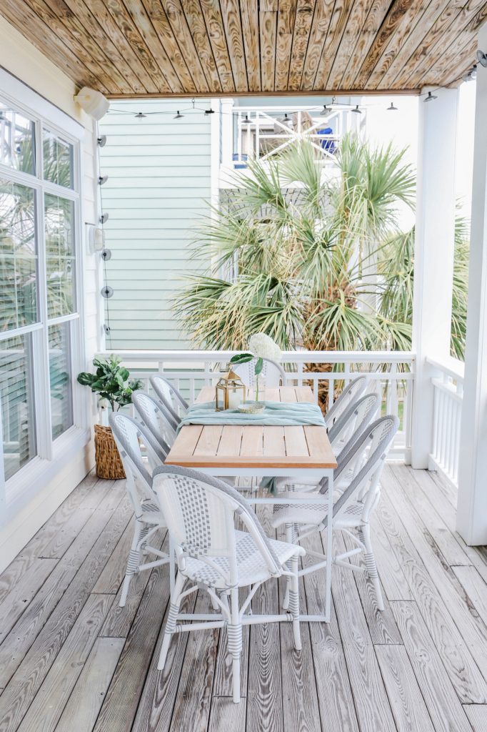 Mid-sized beach style back porch photo in Other with decking and a roof extension by Mary Hannah Interiors | Outdoor Photos | Porch | Landscaping | Landscape Design | Outdoor Living Space | Porch Design Ideas | Outdoor Living Space Ideas | Backyard Design