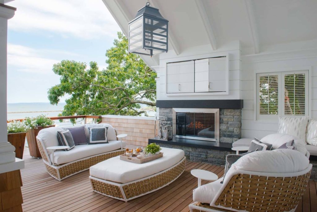 Mid-sized beach style backyard deck photo in New York with a fire pit and a roof extension