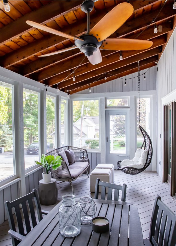 Mid-sized beach style screened-in back porch idea in Milwaukee with a roof extension by Amber Golob Interiors | Outdoor Photos | Porch | Landscaping | Landscape Design | Outdoor Living Space | Porch Design Ideas | Outdoor Living Space Ideas | Backyard Design
