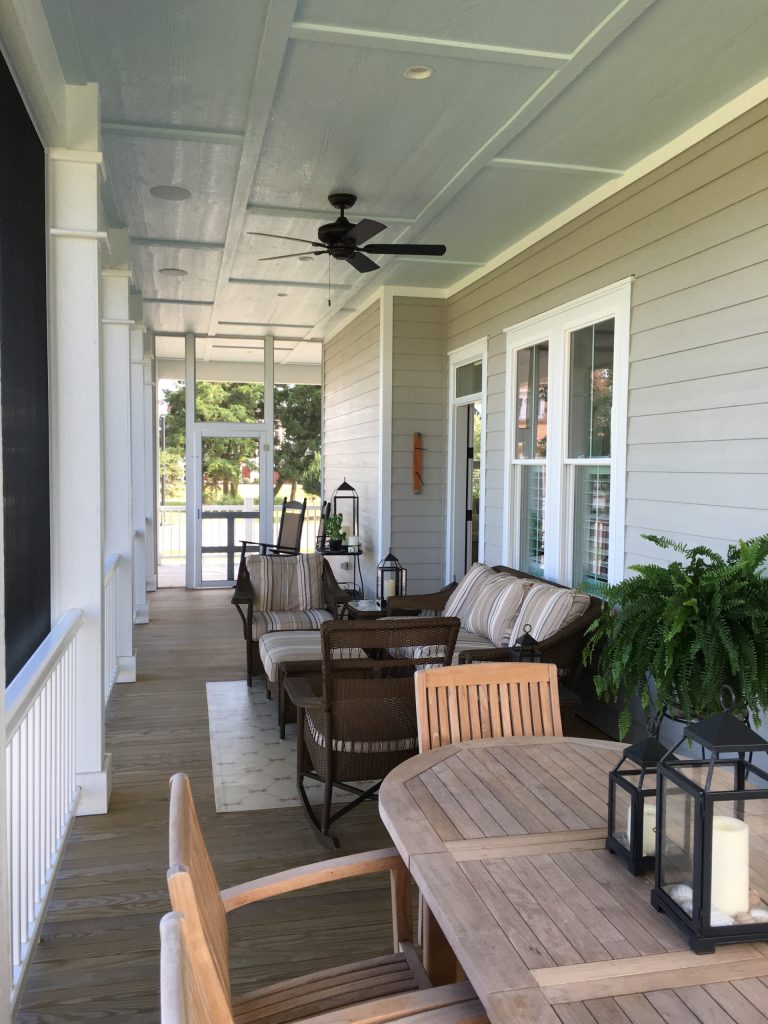 Mid-sized beach style screened-in front porch photo in Other with decking and a roof extension by White Silo | Interior Design Studio | Outdoor Photos | Porch | Landscaping | Landscape Design | Outdoor Living Space | Porch Design Ideas | Outdoor Living Space Ideas | Backyard Design