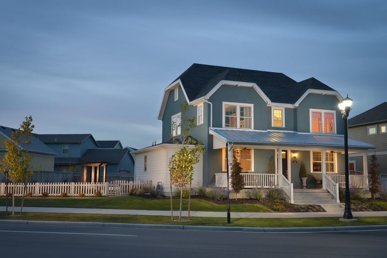 Mid-sized cottage concrete front porch photo in Salt Lake City with a roof extension by Destination Homes | Outdoor Photos | Porch | Landscaping | Landscape Design | Outdoor Living Space | Porch Design Ideas | Outdoor Living Space Ideas | Backyard Design