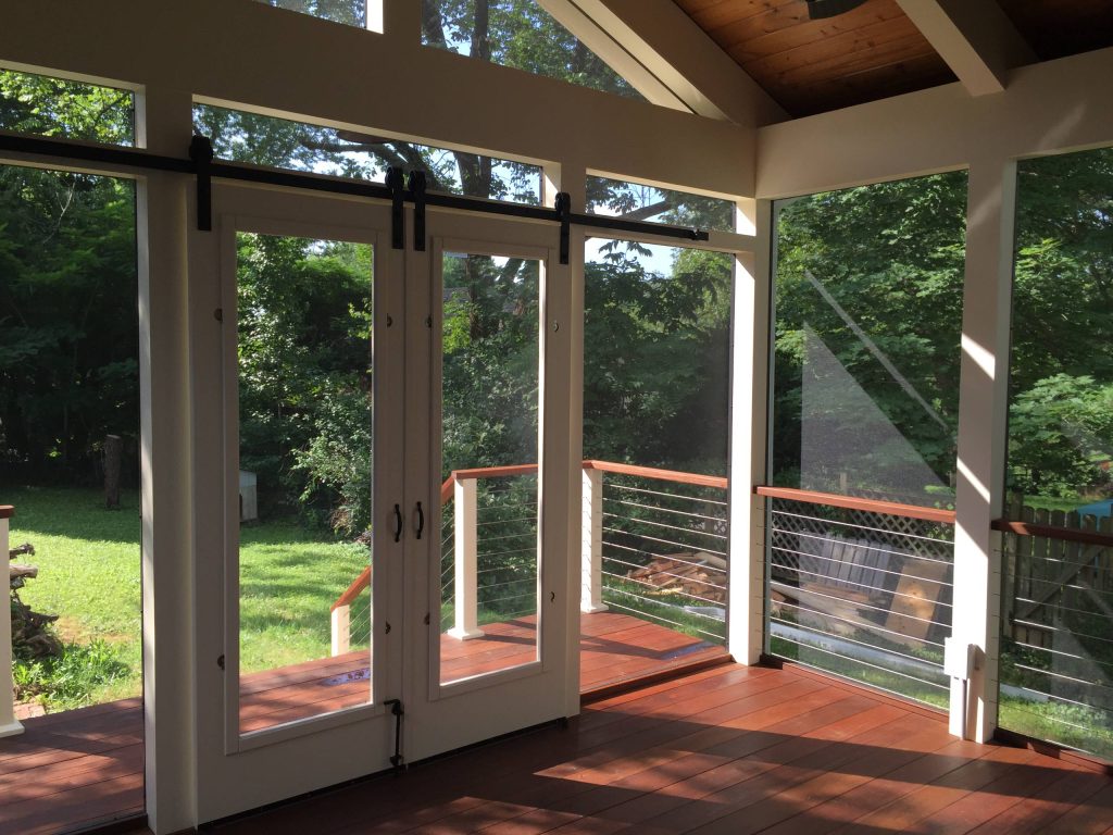 Mid-sized cottage screened-in back porch idea in Other with decking and a roof extension by Integrity Design + Build | Outdoor Photos | Porch | Landscaping | Landscape Design | Outdoor Living Space | Porch Design Ideas | Outdoor Living Space Ideas | Backyard Design