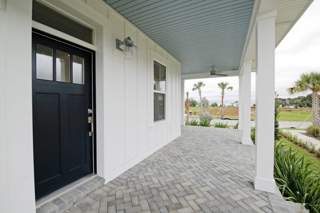 Mid-sized country brick front porch photo in Orlando with a roof extension by J&J Building | Outdoor Photos | Porch | Landscaping | Landscape Design | Outdoor Living Space | Porch Design Ideas | Outdoor Living Space Ideas | Backyard Design