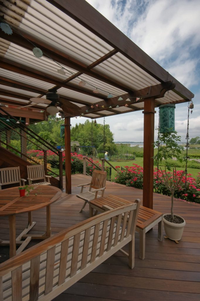 Mid-sized elegant back porch photo in DC Metro with decking and a roof extension by Fine Decks Inc. | Outdoor Photos | Porch | Landscaping | Landscape Design | Outdoor Living Space | Porch Design Ideas | Outdoor Living Space Ideas | Backyard Design