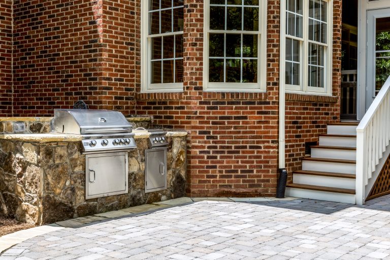 Mid-sized elegant backyard brick patio kitchen photo in Charlotte with no cover