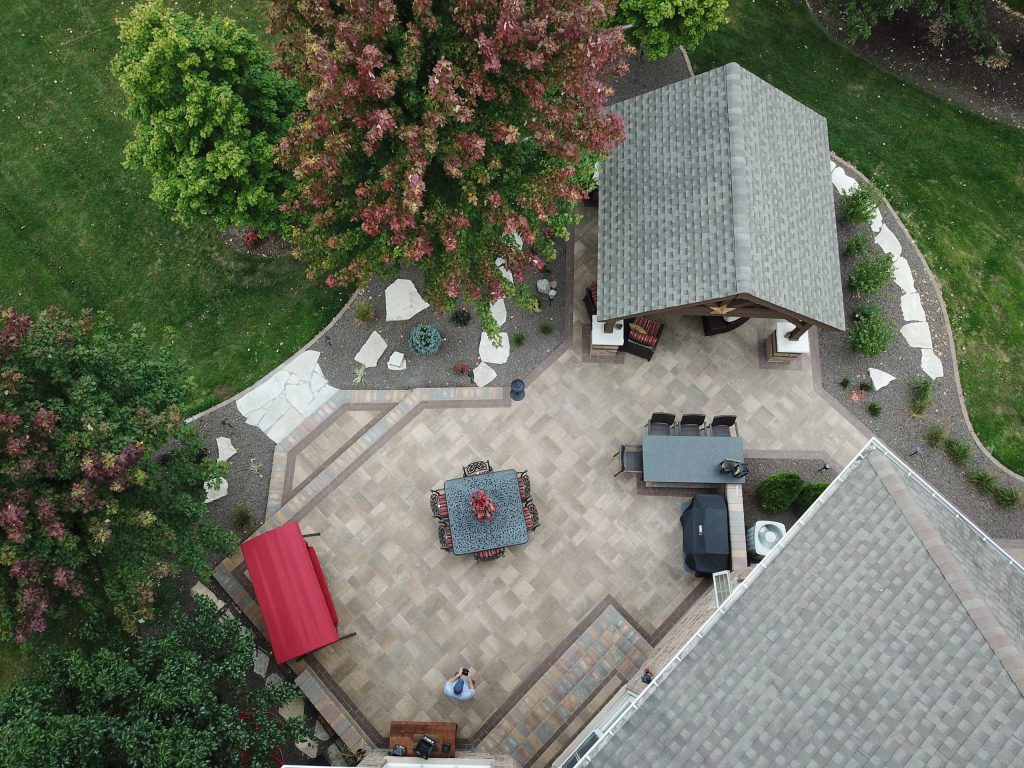 Mid-sized elegant backyard brick patio kitchen photo in Chicago with a gazebo