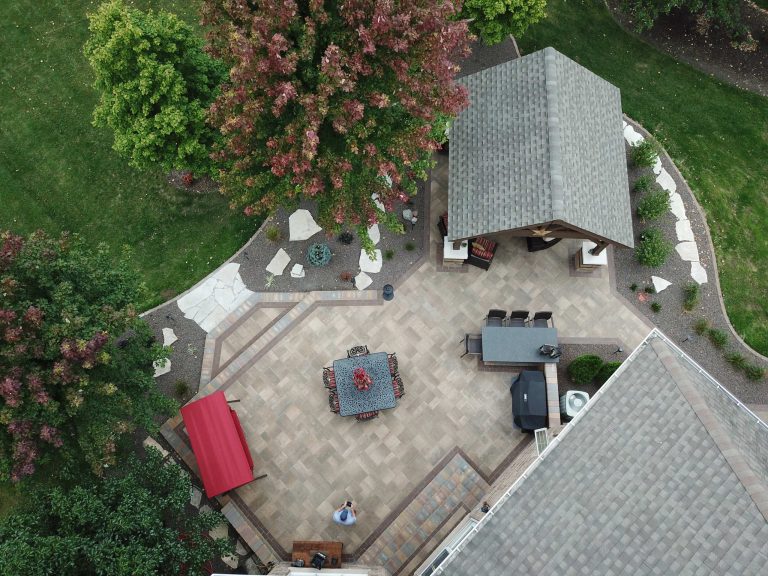 Mid-sized elegant backyard brick patio kitchen photo in Chicago with a gazebo