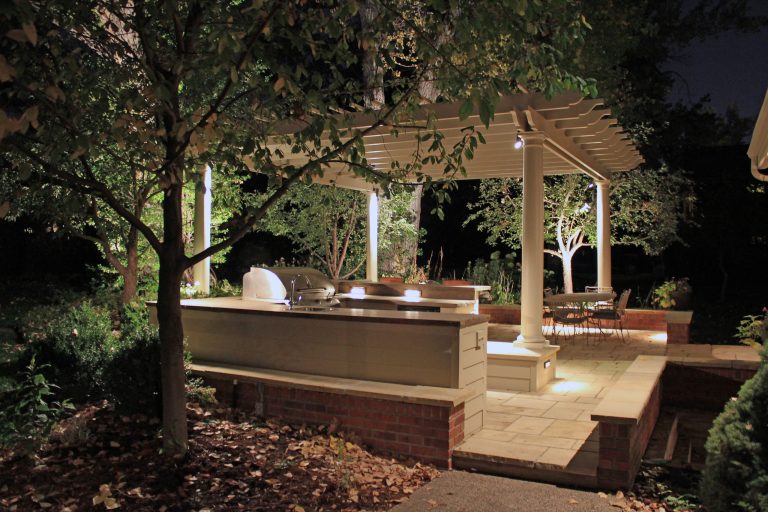 Mid-sized elegant backyard brick patio kitchen photo in Denver with a pergola