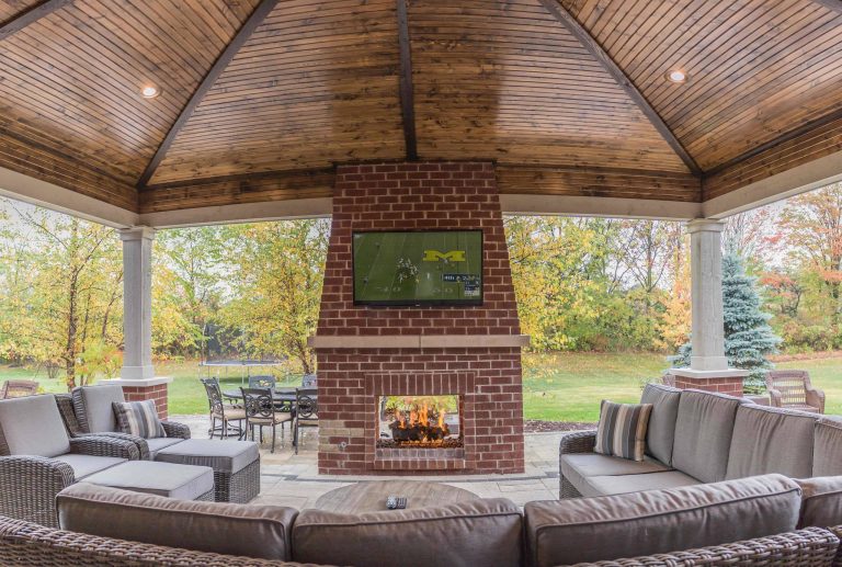 Mid-sized elegant backyard brick patio kitchen photo in Detroit with a roof extension