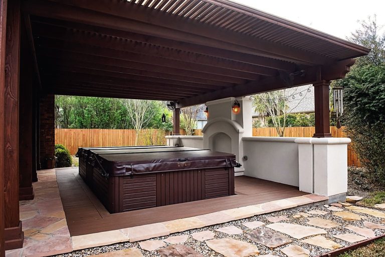 Mid-sized elegant backyard concrete patio kitchen photo in Houston with a pergola