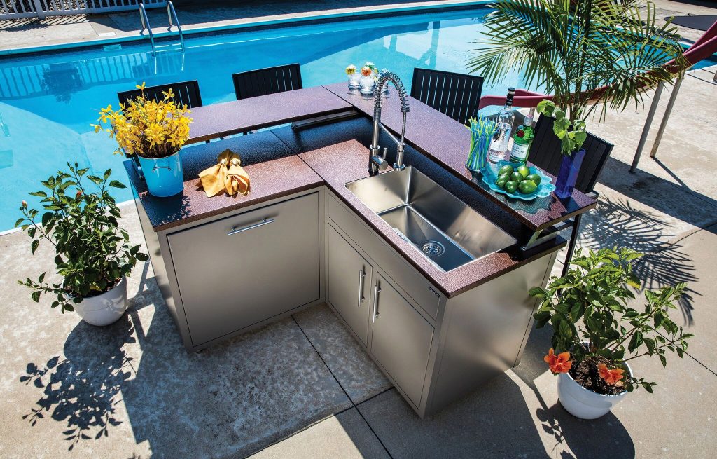 Mid-sized elegant backyard concrete patio kitchen photo in Other with no cover