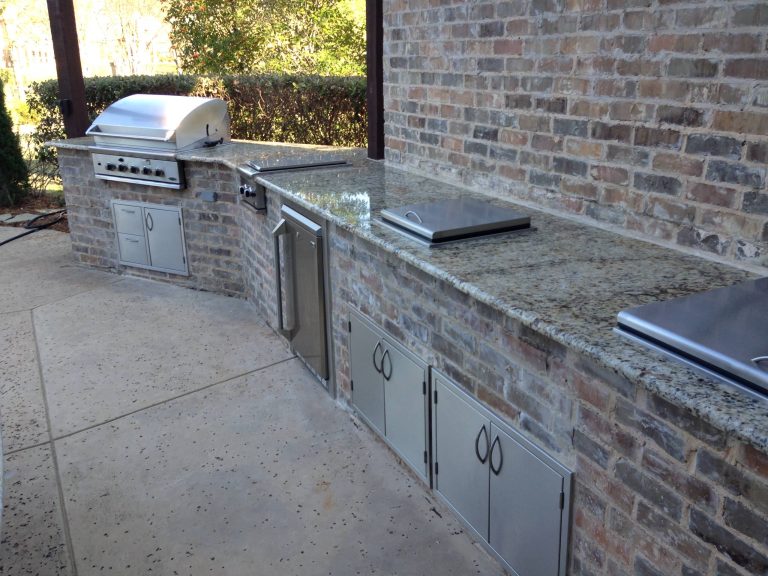 Mid-sized elegant backyard concrete patio kitchen photo with no cover