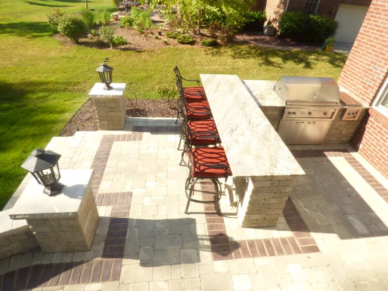 Mid-sized elegant backyard concrete paver patio kitchen photo in Detroit with no cover