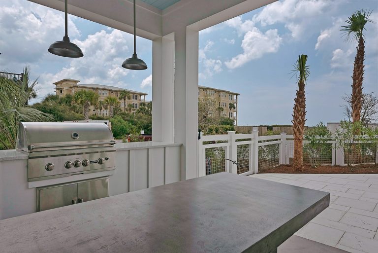 Mid-sized elegant backyard concrete paver patio kitchen photo in Miami with a roof extension