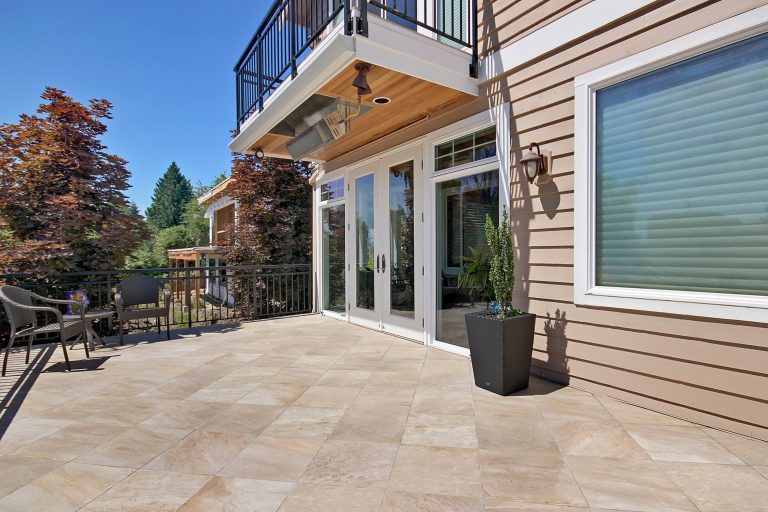 Mid-sized elegant backyard deck photo in Seattle with a fire pit and a roof extension
