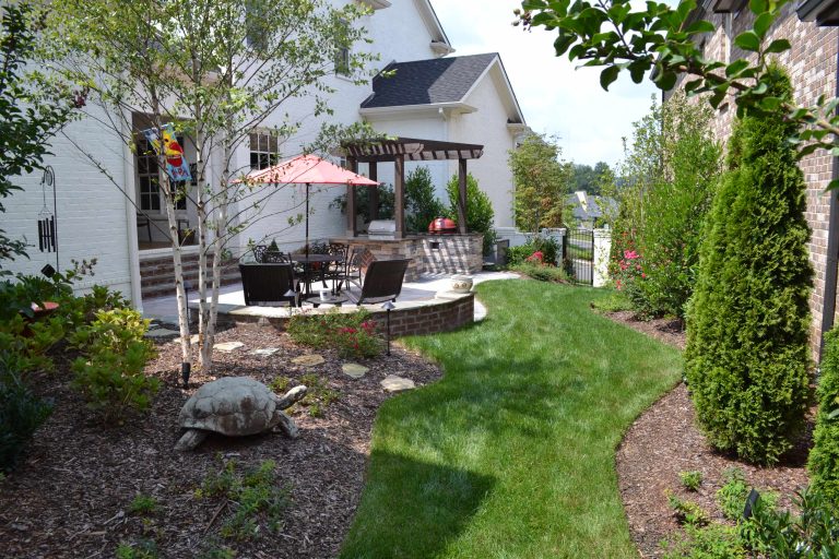 Mid-sized elegant backyard outdoor kitchen deck photo in Nashville with a pergola