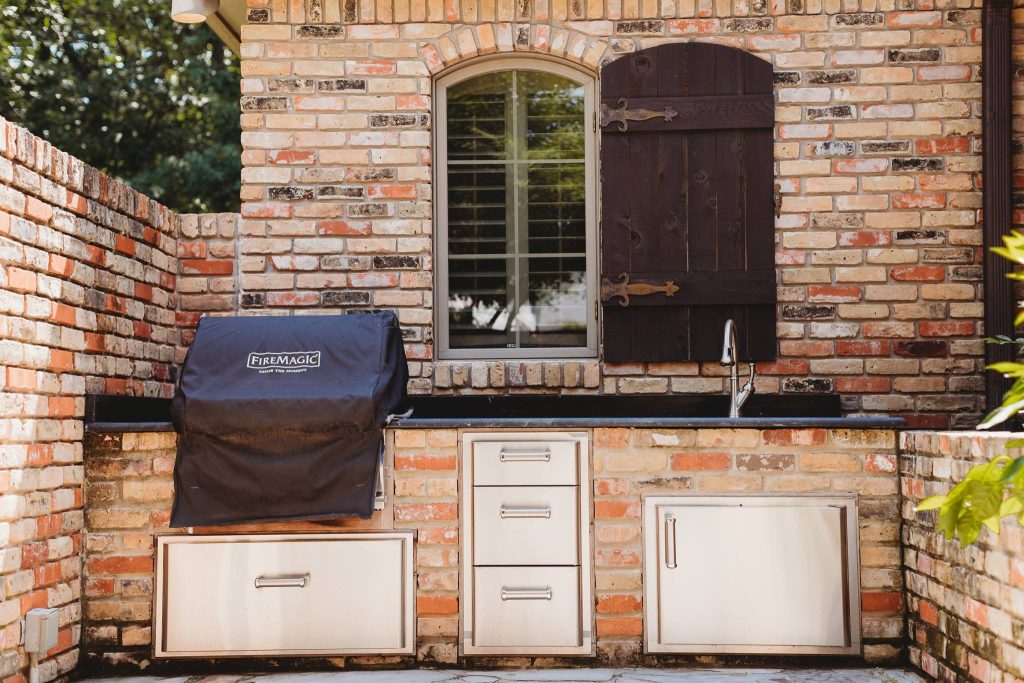 Mid-sized elegant backyard patio kitchen photo in New Orleans with no cover