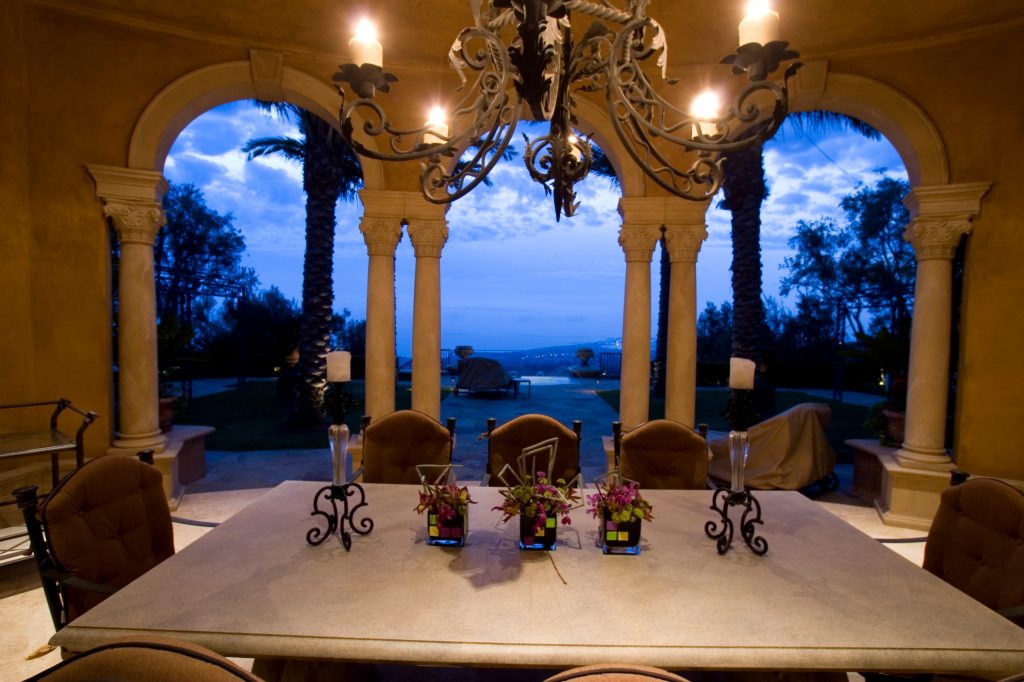 Mid-sized elegant backyard patio kitchen photo in Orange County with a roof extension