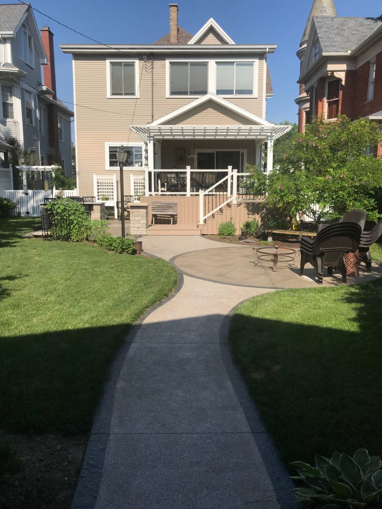 Mid-sized elegant backyard patio kitchen photo in Other with decking and a pergola
