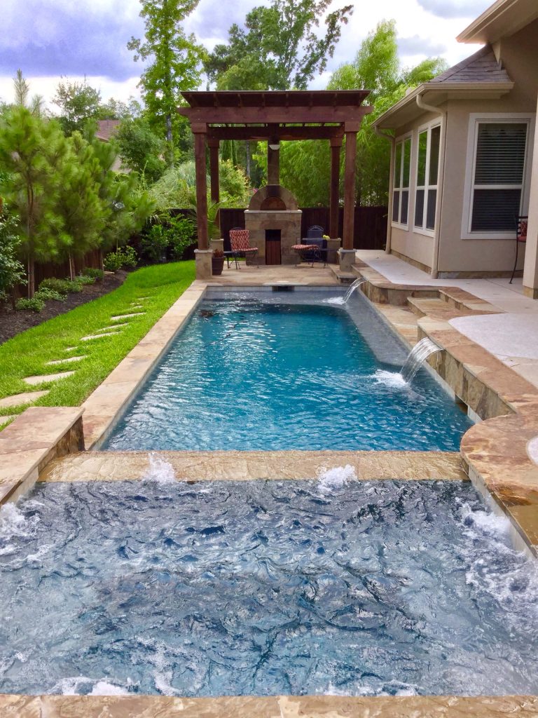 Mid-sized elegant backyard stone and rectangular lap hot tub photo in Houston