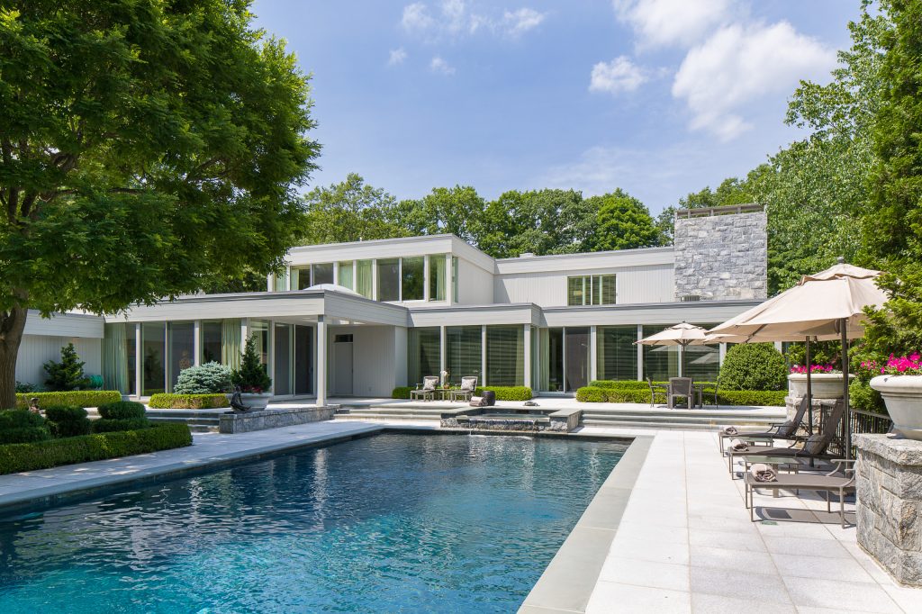 Mid-sized elegant backyard stone and rectangular lap hot tub photo in New York